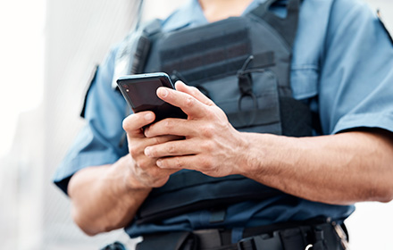 Police Officer Looking Through a Person's Phone After a Traffic Stop