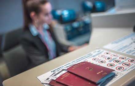 Passport in front of Airport Security Counter Showing the Long-Term Consequences of Customs Violations
