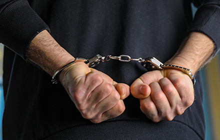 Close-Up of Hands in Handcuffs Following an Arrest