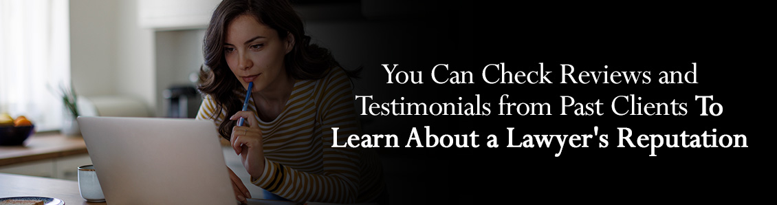 Woman Reading Online Reviews on a Laptop Before Choosing a Criminal Defense Lawyer