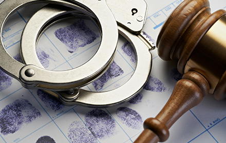 Handcuffs and Gavel on Top of Criminal Record To Represent a Defendant's Options After an Arrest