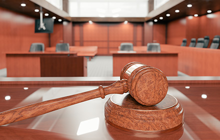 Judge Gavel in Empty Courtroom To Represent the Trial Experience of Our Legal Team