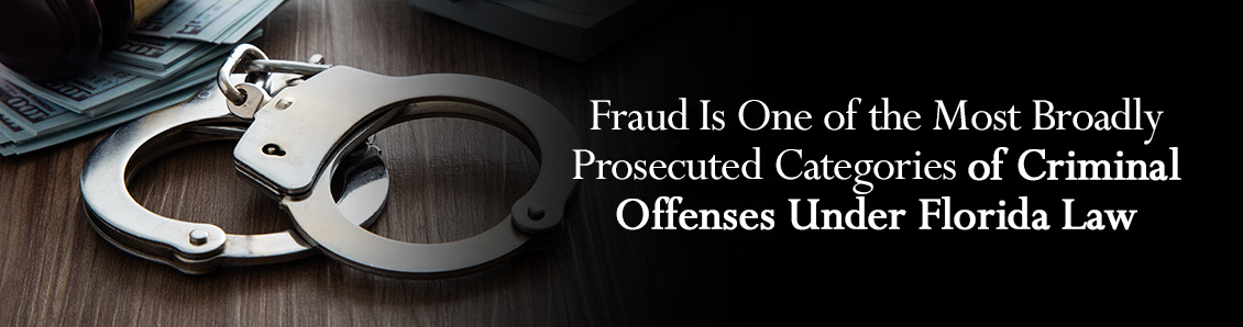 Wad of Money Next to Handcuffs To Represent the Prosecution of Fraud-Related Offenses