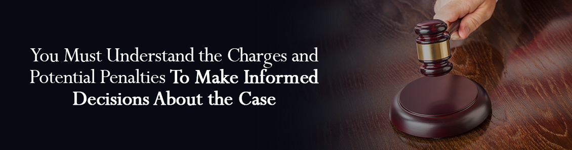 Hand Holding Judge Gavel to Represent the Potential Penalties of a Criminal Trial