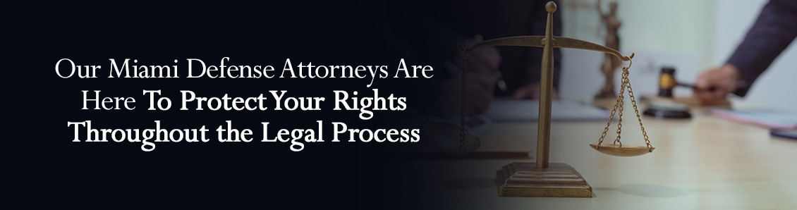 Scales of Justice and Defense Attorney Holding Gavel During a Legal Process