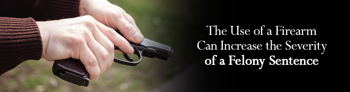 Close-Up of Hands Loading a Firearm, Which Increases the Severity of a Felony Sentence