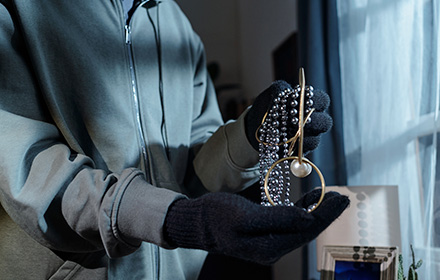 Close-Up of Gloved Hands Holding Jewelry During Grand Theft Attempt
