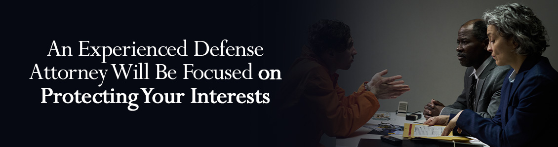 Defendant Going Over a Case with Defense Team and Looking Over Case Documents