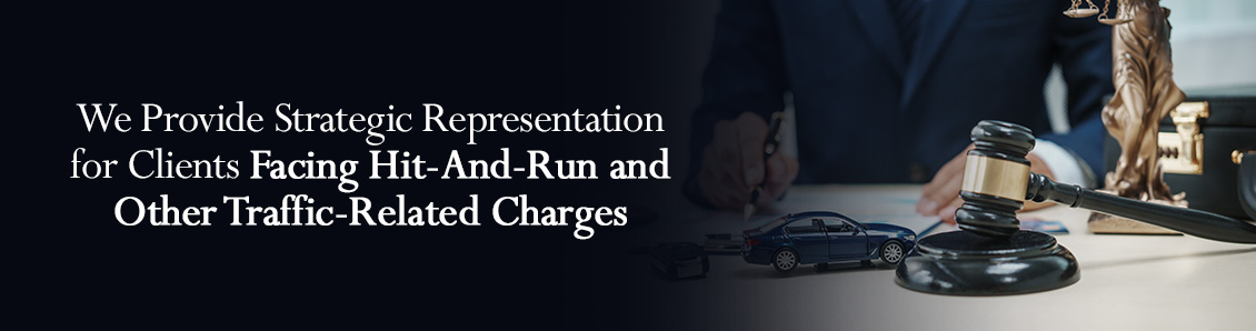 Defense Lawyer With Case Documents, Gavel, Scales of Justice, and Car Figurine on Top of Desk