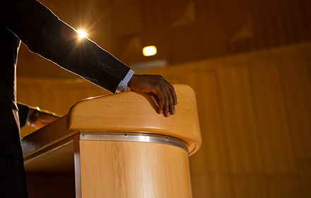 Close-Up of Hand Resting on Podium During a Legal Process in Court